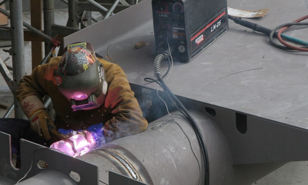 Worker Welding on Ship Hull